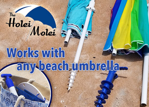 A beach umbrella and some other items on the ground.