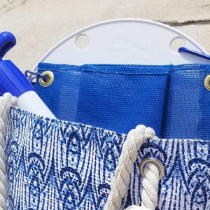 A blue bag with rope handles and a white handle.