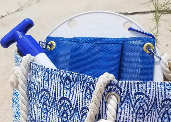 A blue bag with rope handles and a white handle.